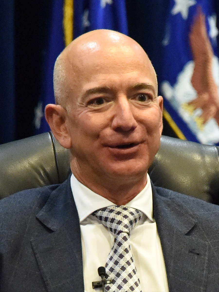 Jeff Bezos, founder of Amazon, in a dark suit and checked tie.